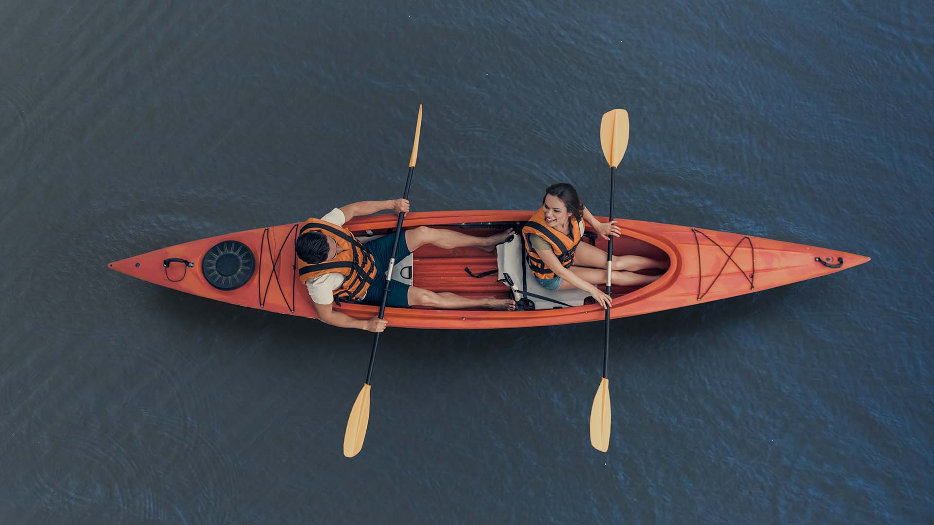 A man and woman in a tandem kayak