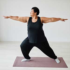 senior woman enjoying standing yoga pose