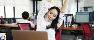 woman stretching at her desk