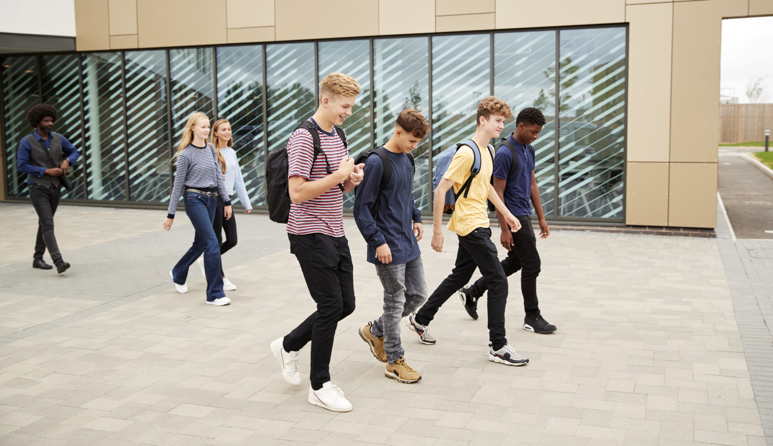 A group of high school students walking to school. 