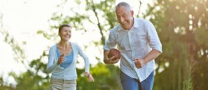 Elderly couple playing football