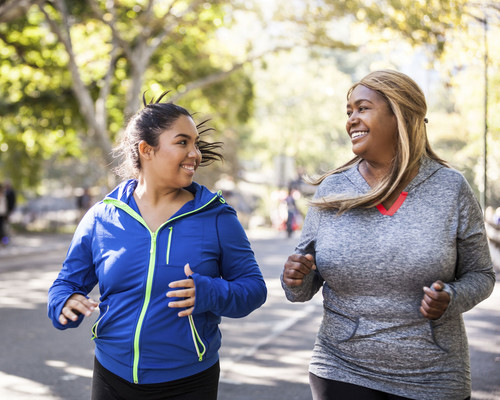 Two women running and smiling