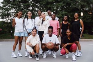 A photo of Olivia Ho standing with a group of women who she gets active with by playing basketball. 