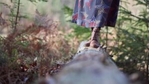 a person feet on a tree trunk