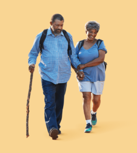 An older man and woman hiking. 