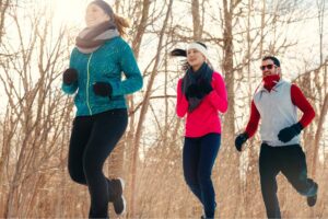 A group of people running outdoors, a great way to move for your mood. 