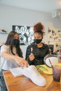 Olvia Ho and her student making a basketball planter.