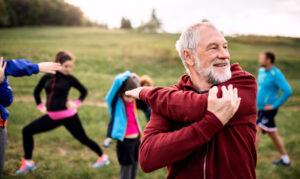 Large,Group,Of,Fit,And,Active,People,Doing,Exercise,In