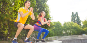 woman and man exercising in a park