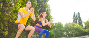 woman and man exercising in a park