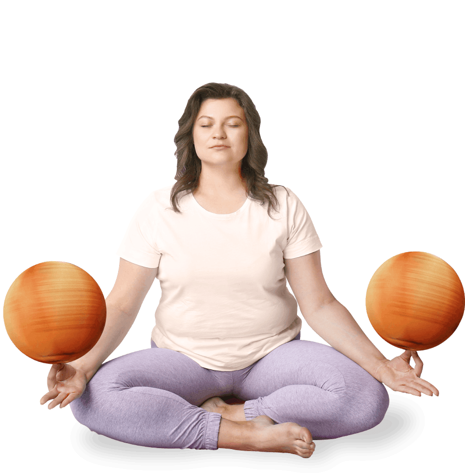 A woman sitting cross legged balancing two basketballs