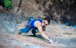 Jill Wheatley climbing up a cliff face in Nepal