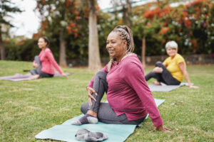 A group of women doing yoga at a park. 