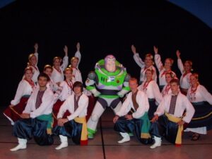 Stephanie Ehmke and fellow Ukrainian dancers posing with a person wearing a Buzz Lightyear costume.