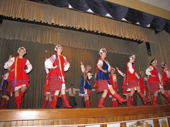 Stephanie Ehmke and fellow Ukrainian dancers dancing on a stage. Stephanie Ehmke and fellow Ukrainian dancers dancing on a stage.