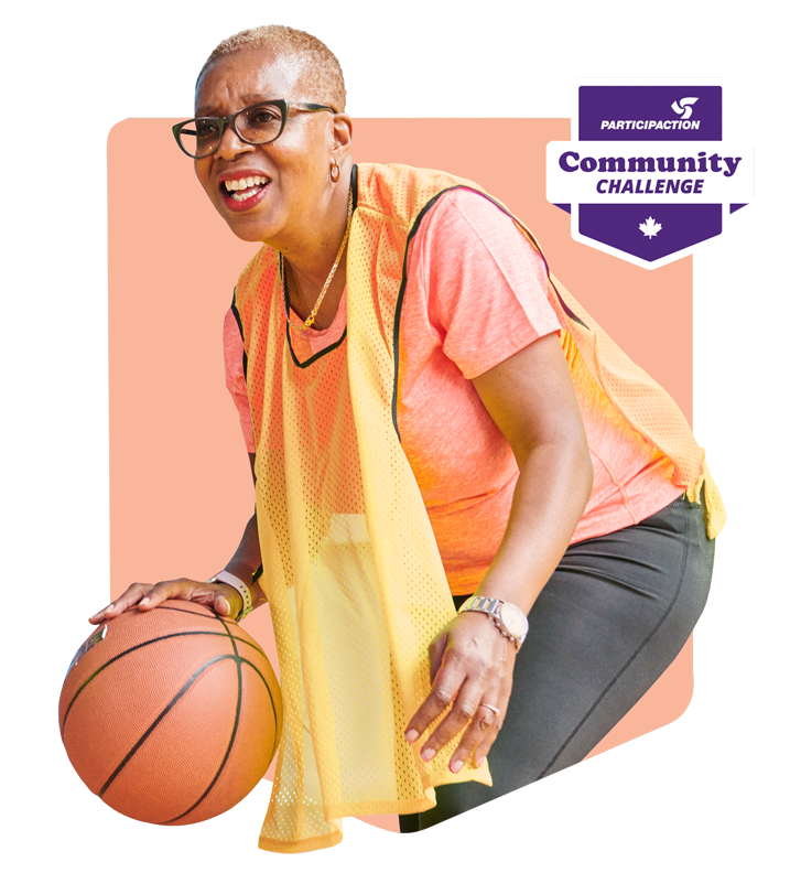 A woman playing basketball with a yellow jersey on.