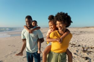 A family walking on a sandy beach.