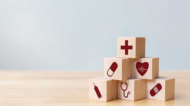 wooden blocks with health symbols like heart, cross, pill etc wooden blocks with health symbols like heart, cross, pill etc
