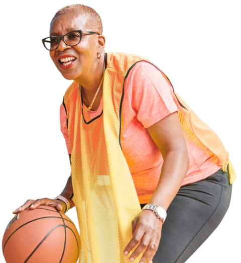 woman smiling and dribbling basketball