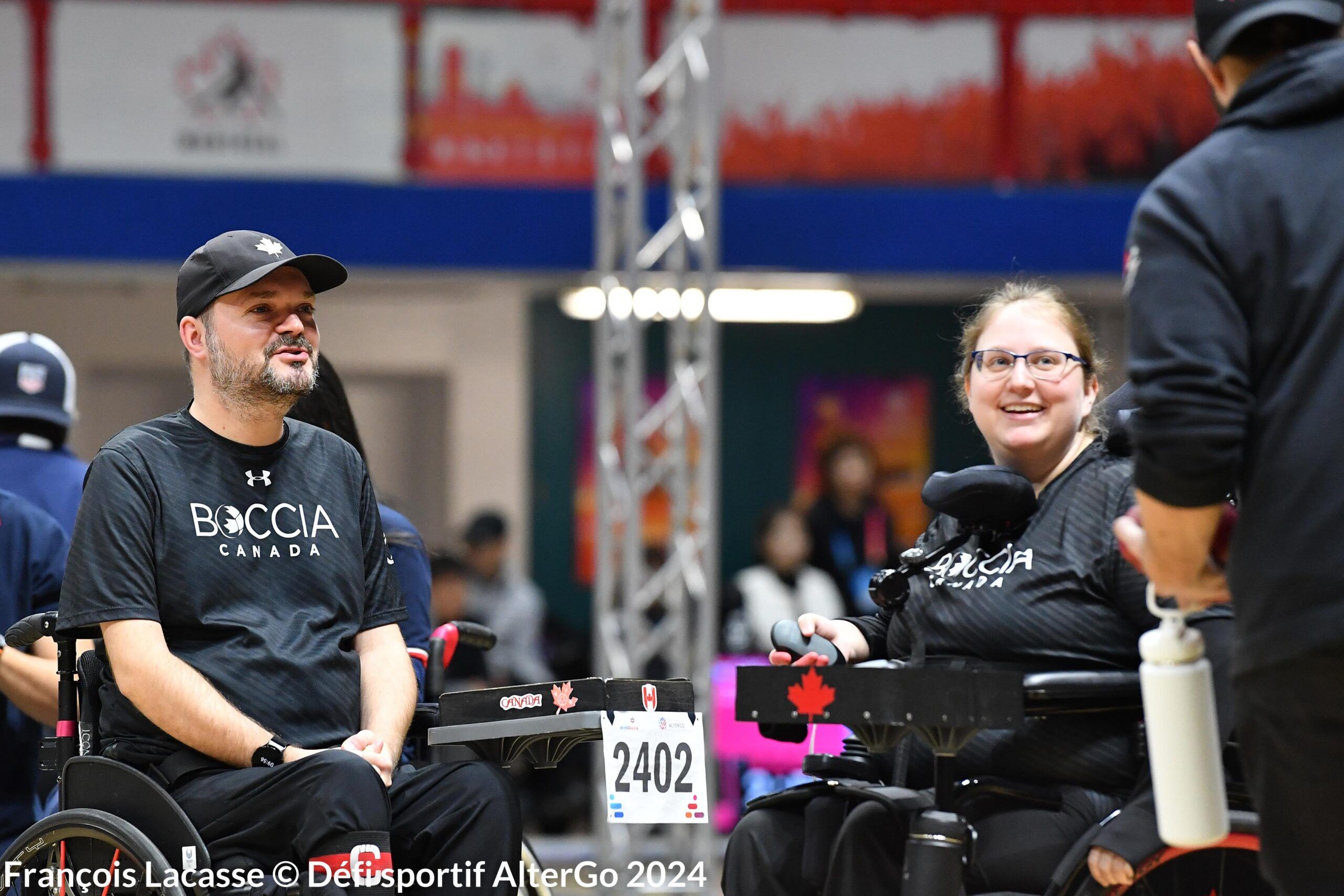 Iulian Ciobanu and Alison Levine talking to their boccia coach. Iulian Ciobanu and Alison Levine talking to their boccia coach.