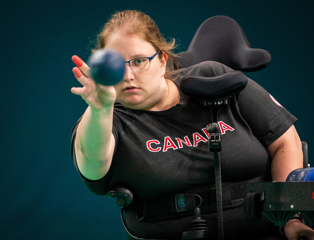Paralympian Alison Levine throwing a boccia ball. Paralympian Alison Levine throwing a boccia ball.