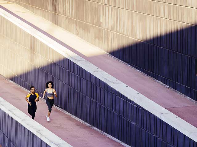 overhead view of two people running on a walkway overhead view of two people running on a walkway