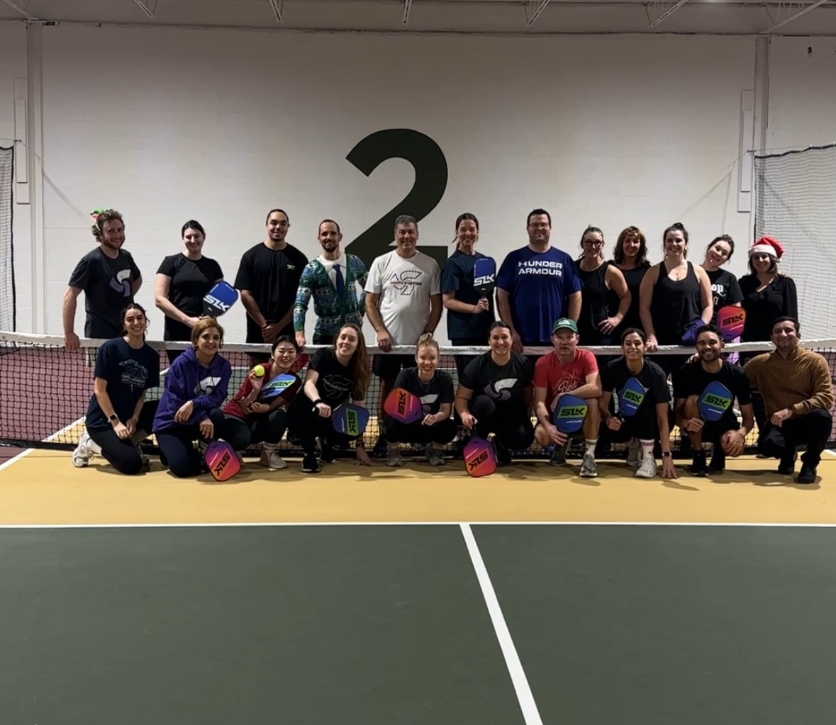 A group photo of the ParticipACTION team on a pickleball court. A group photo of the ParticipACTION team on a pickleball court.