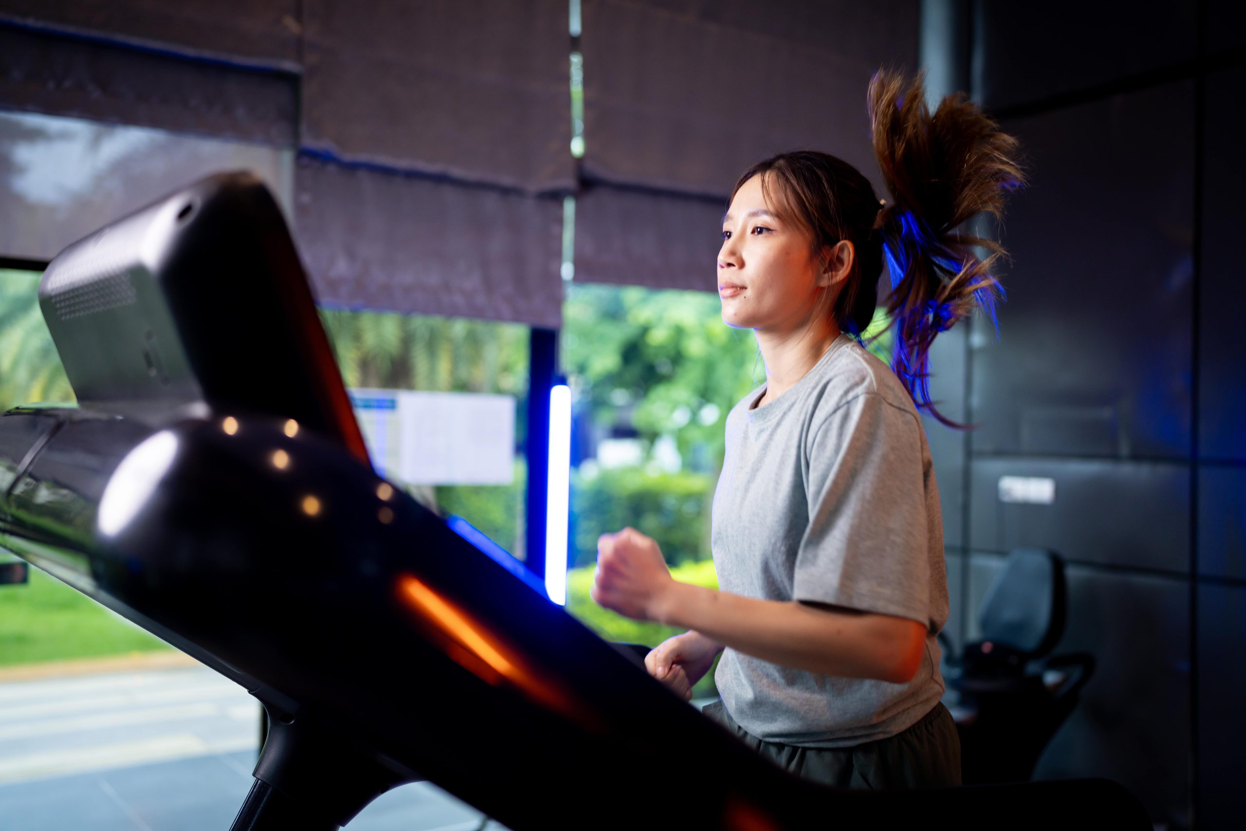 A woman running on a treadmill. A woman running on a treadmill.