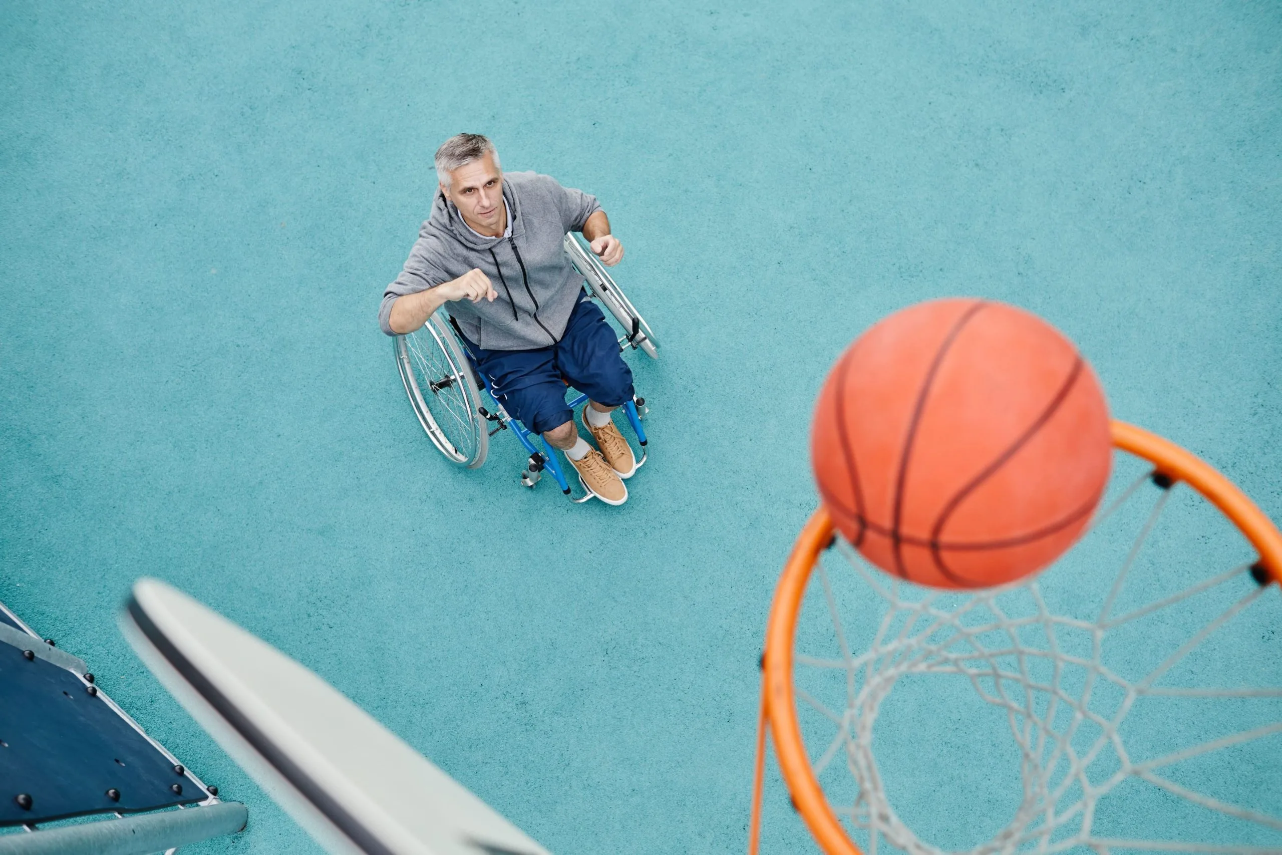 Newsletter-min-scaled-3-scaled Man in wheelchair playing basketball