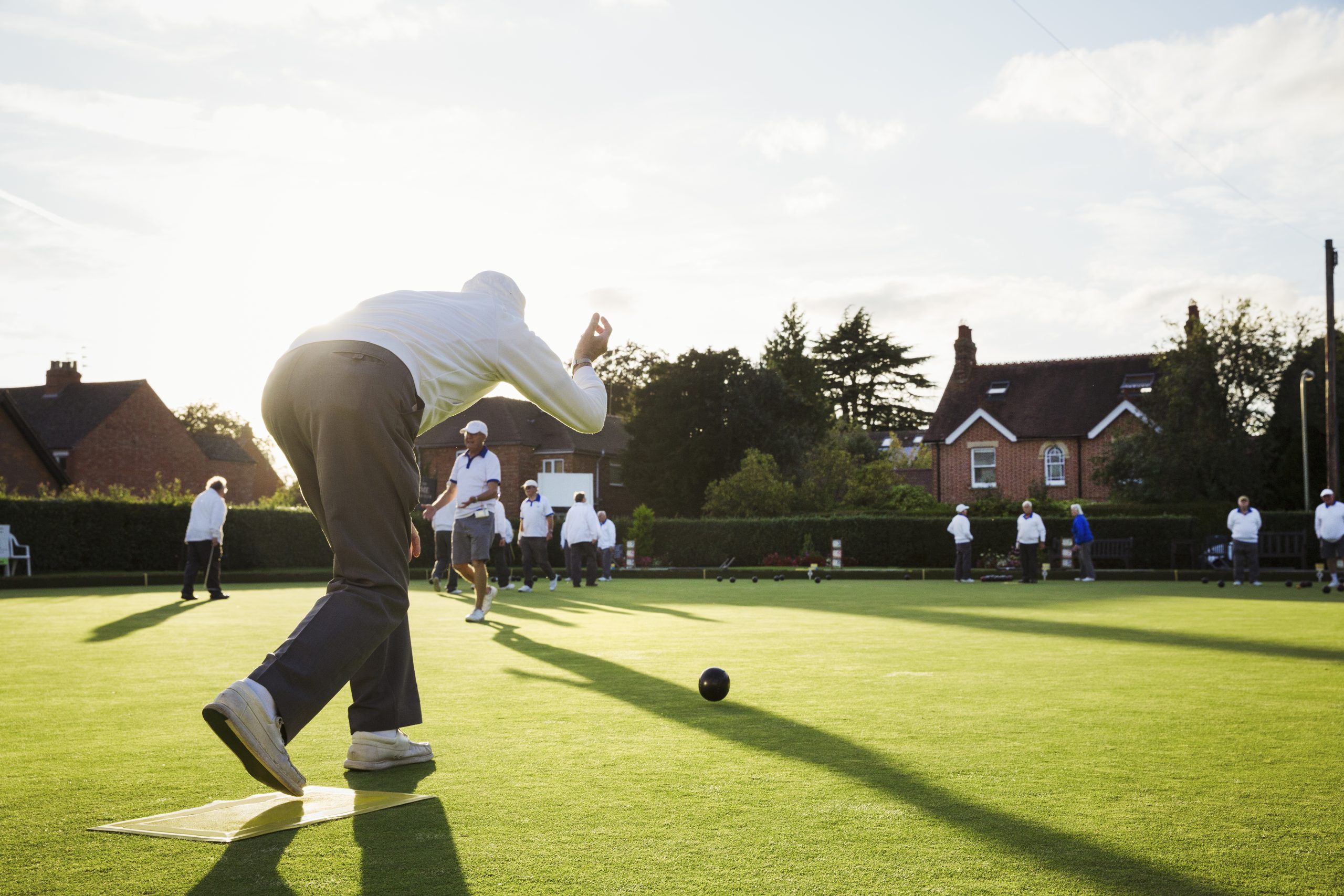 A group of people playing bowls. A group of people playing bowls.