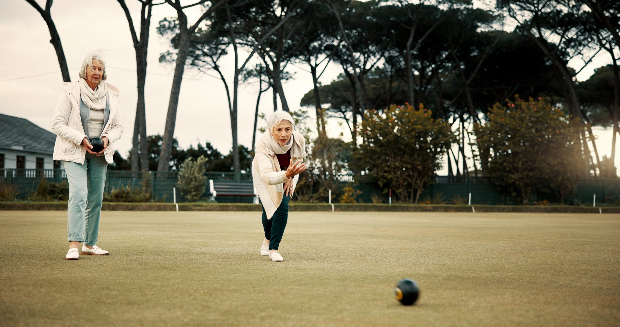 Two women playing bowls. Two women playing bowls.