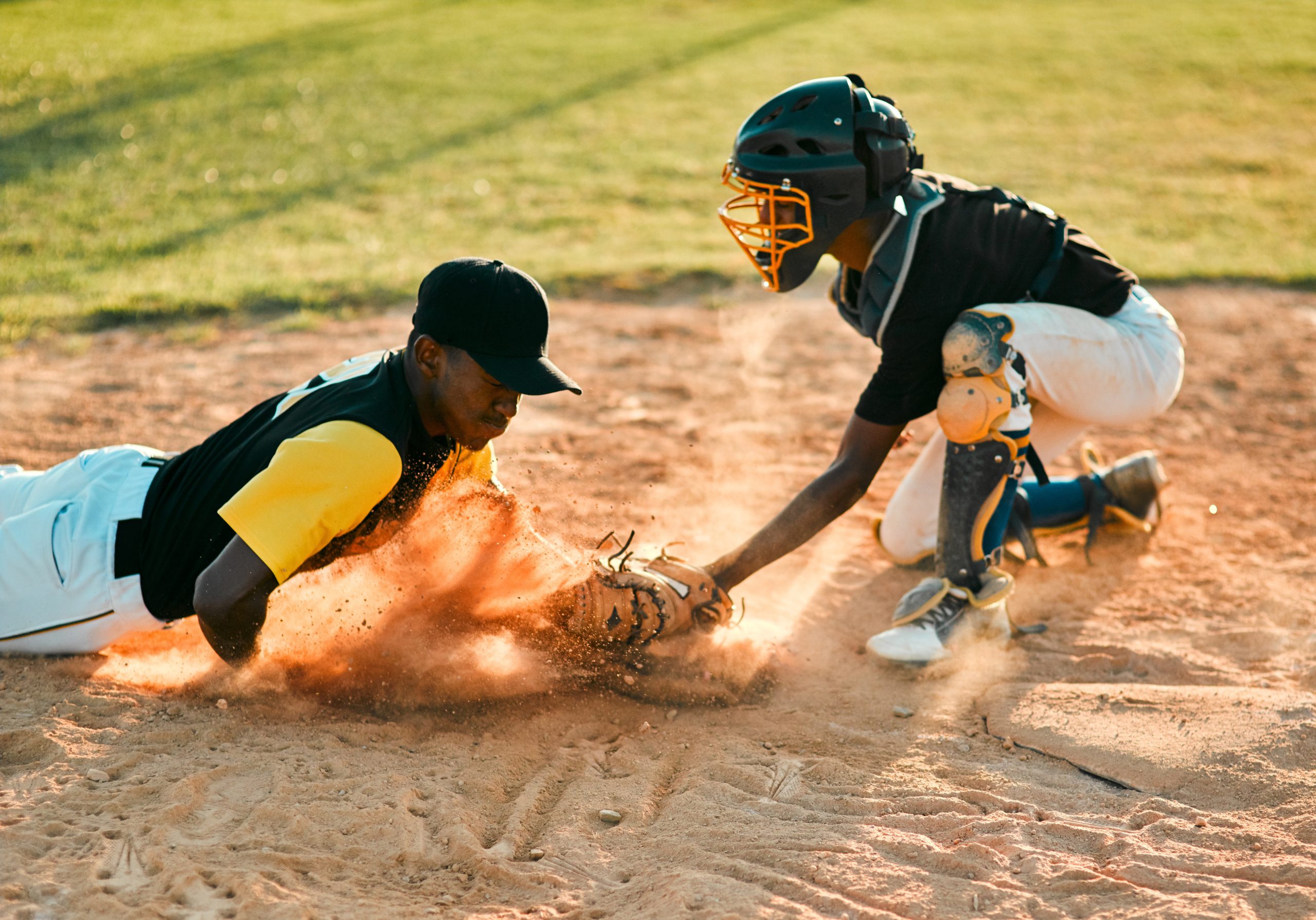 A softball player sliding into home plate. A softball player sliding into home plate.