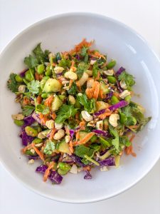 Edamame crunch salad with cucumber, carrot, red cabbage, scallions, cilantro and cashews.