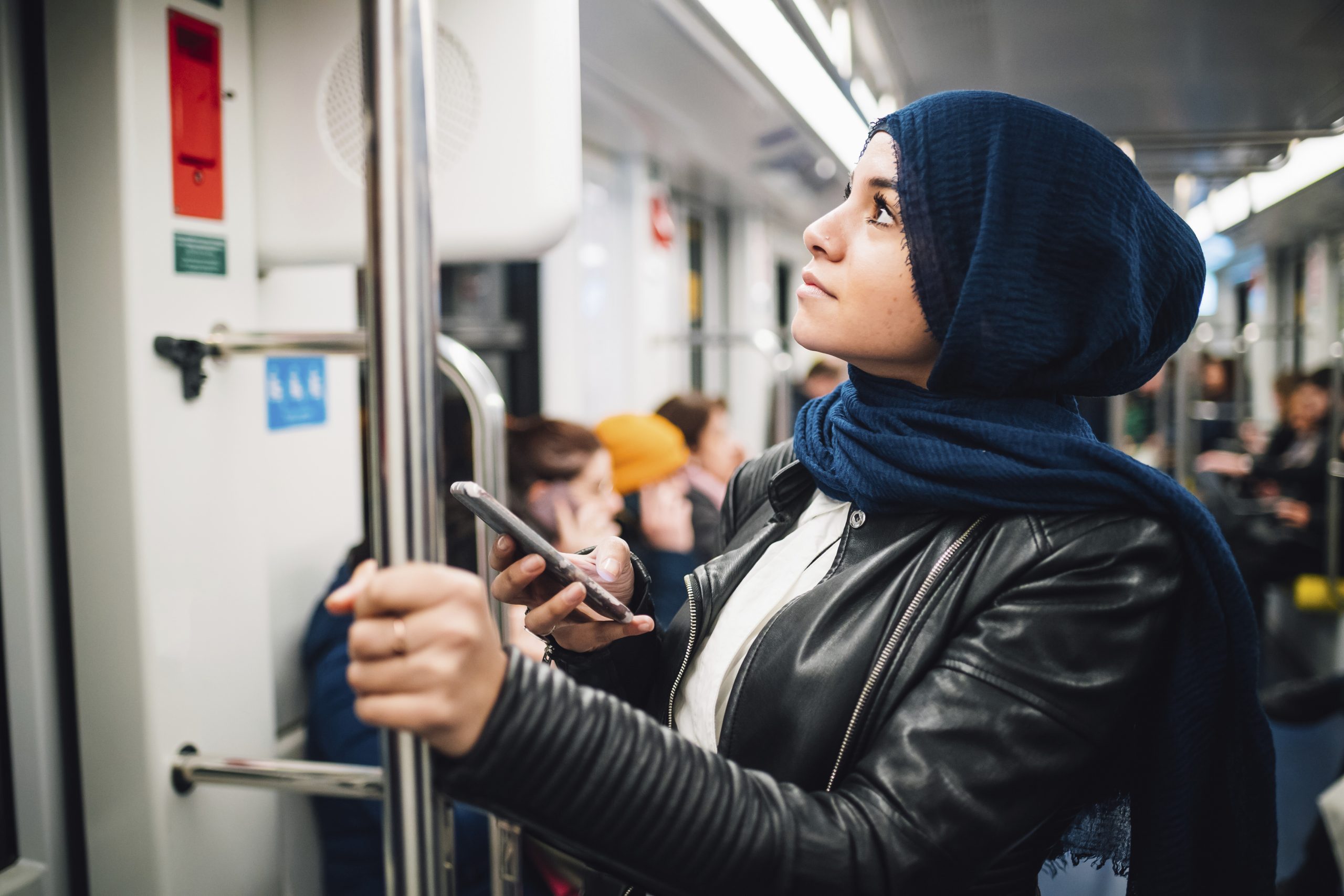 A person standing on a subway train.  