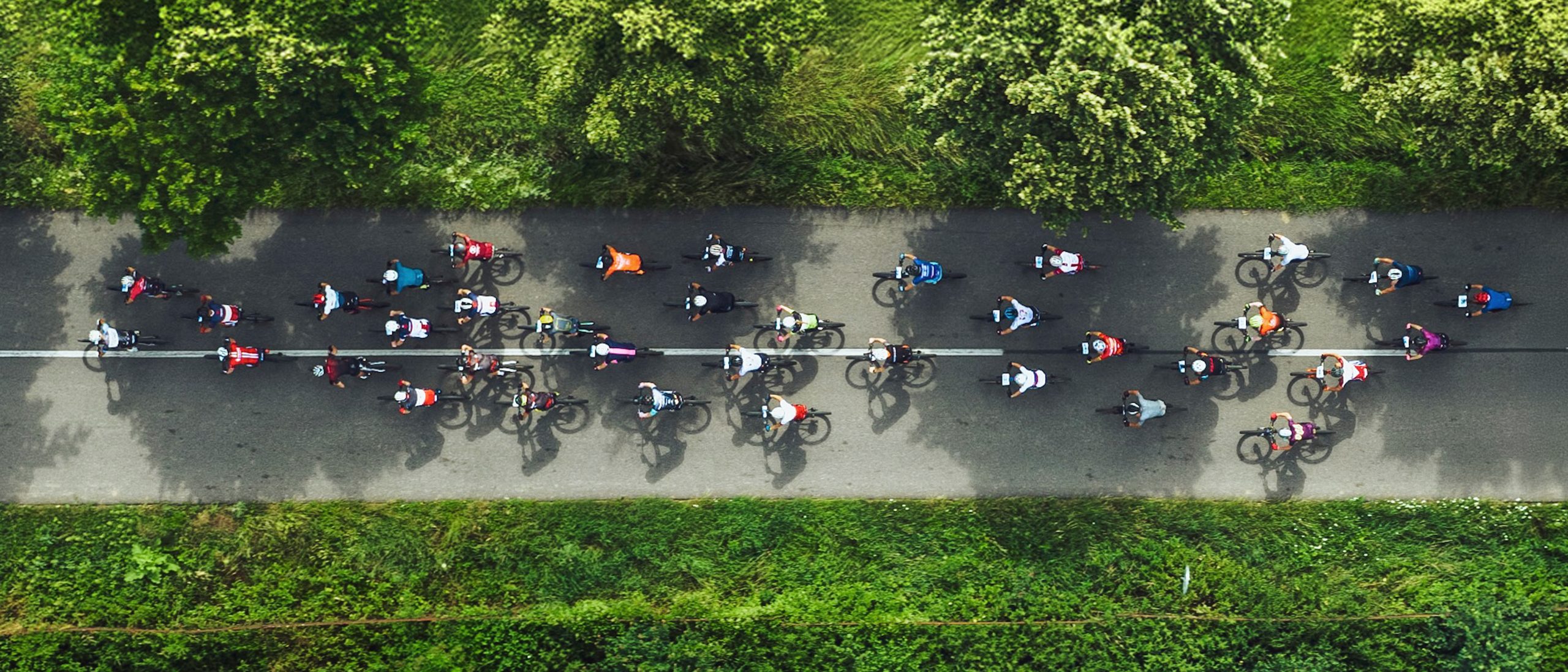 An aerial view of a group of people cycling on a road. How to follow the Canadian 24-Hour Movement Guidelines for Adults