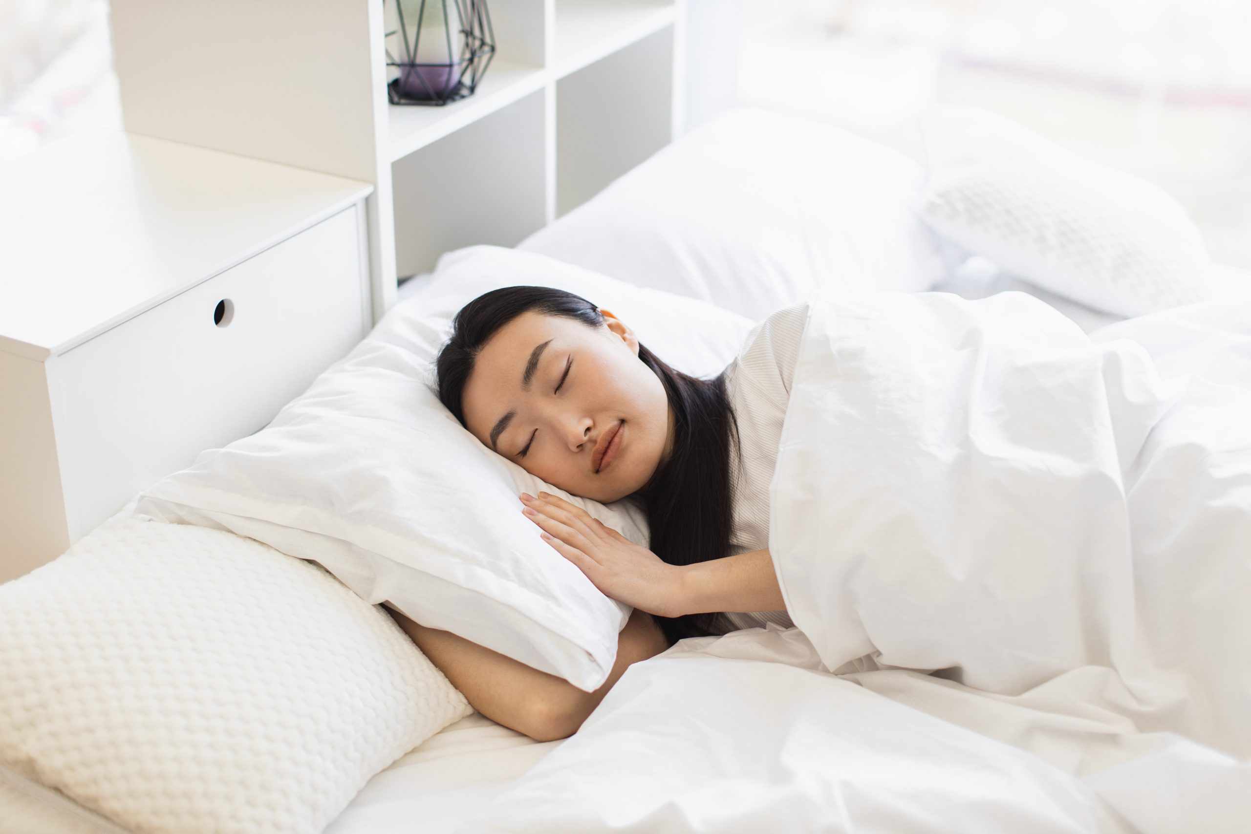 A woman sleeping in a bed.  